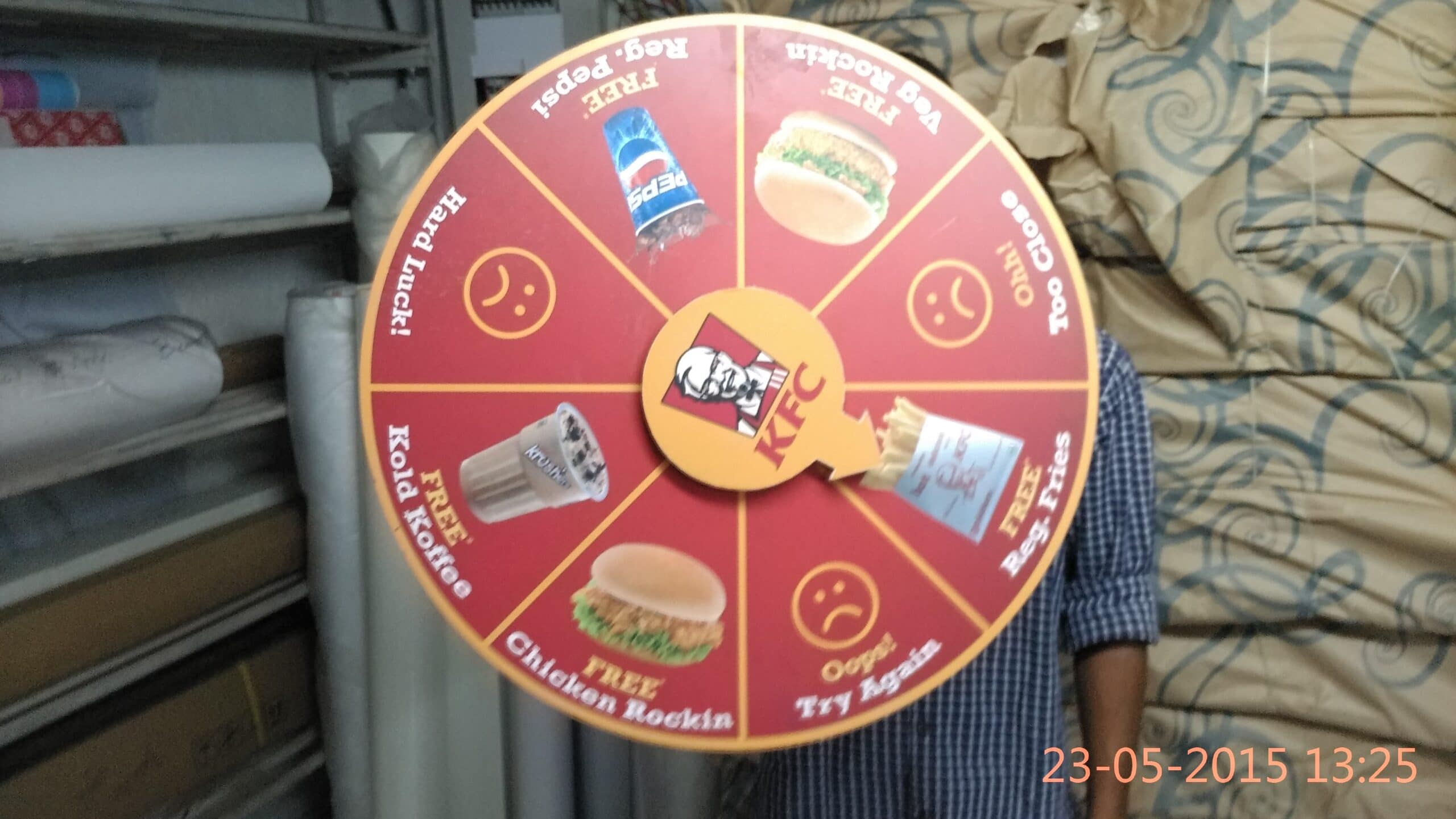 Wheel of fortune game created for KFC. The wheel is rotated and when it stops the arrow points to one section. The player wins the gift printed in that section. This makes for a superb and novel party idea.