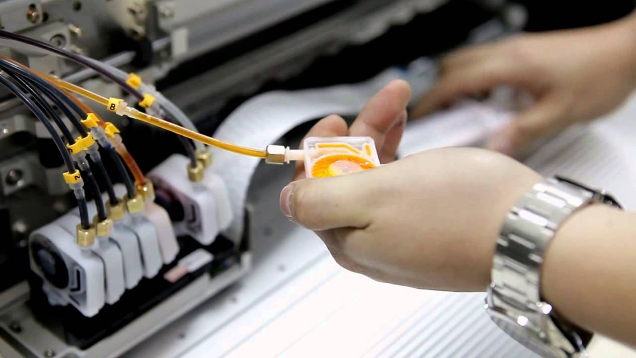 technician cleaning the inkjet head of a wide format printer