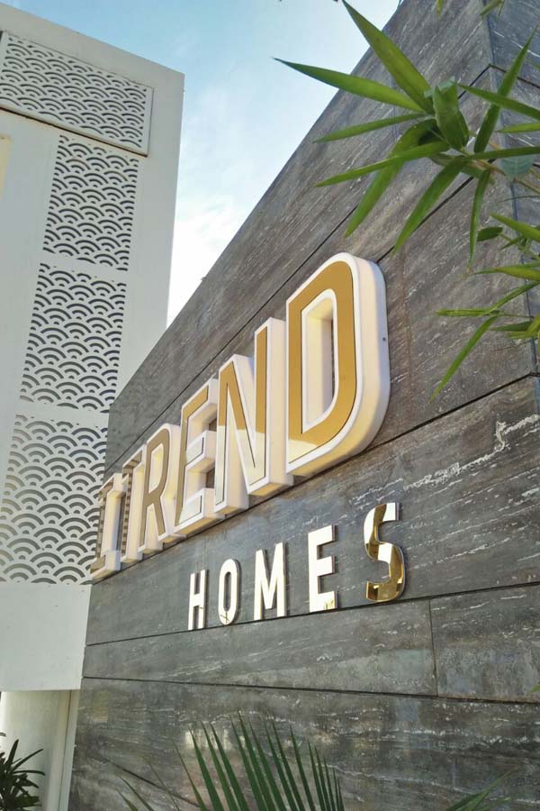 Laser cut letters in 3D made of white acrylic with shiny mirror gold surface on the front. Letters are mounted directly on to the wall