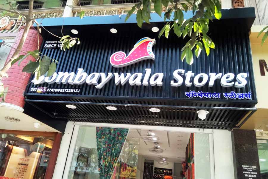 Shop sign board made in 3D acrylic letters and logos mounted on a black metal frame