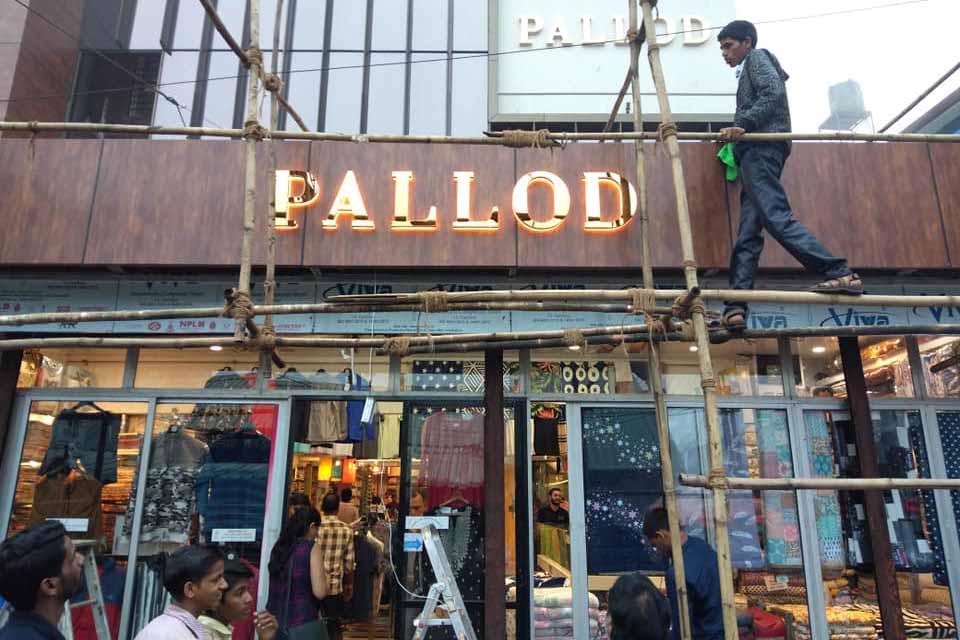 Shop board made of a highly polished gold metallic letters with a LED back glow. Letters installed directly on the wall above the shop