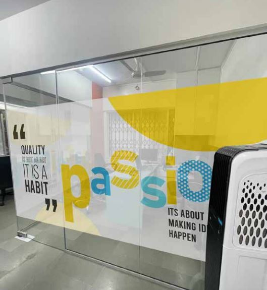 A motivational quote printed on a frosted glass film print pasted on the glass panel partitions of a Wellness Center