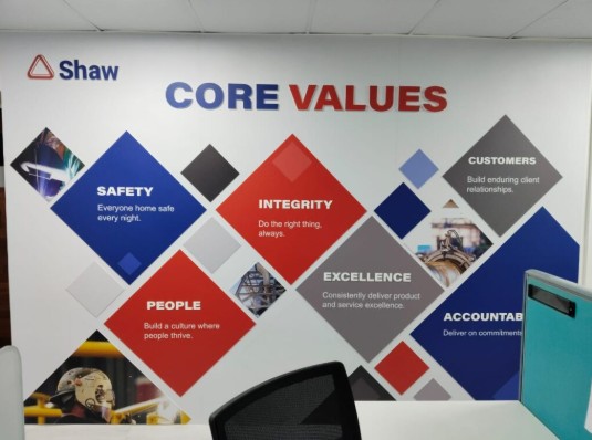the core values of the Shaw company displayes on acrylic plates installed in their corporate office