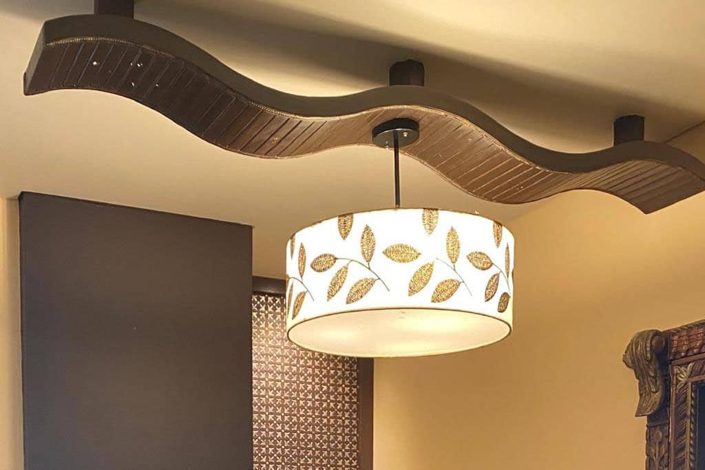 An abstract canvas print wrapped around a cylindrical frame with a light source inside to create a very unique kind of lampshade