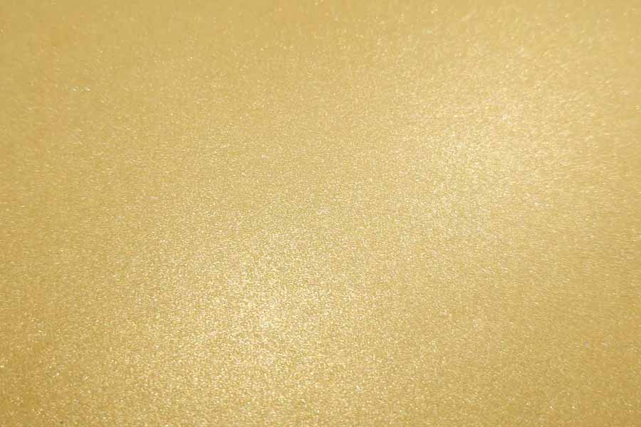 Gold metallic paper glittering under a light