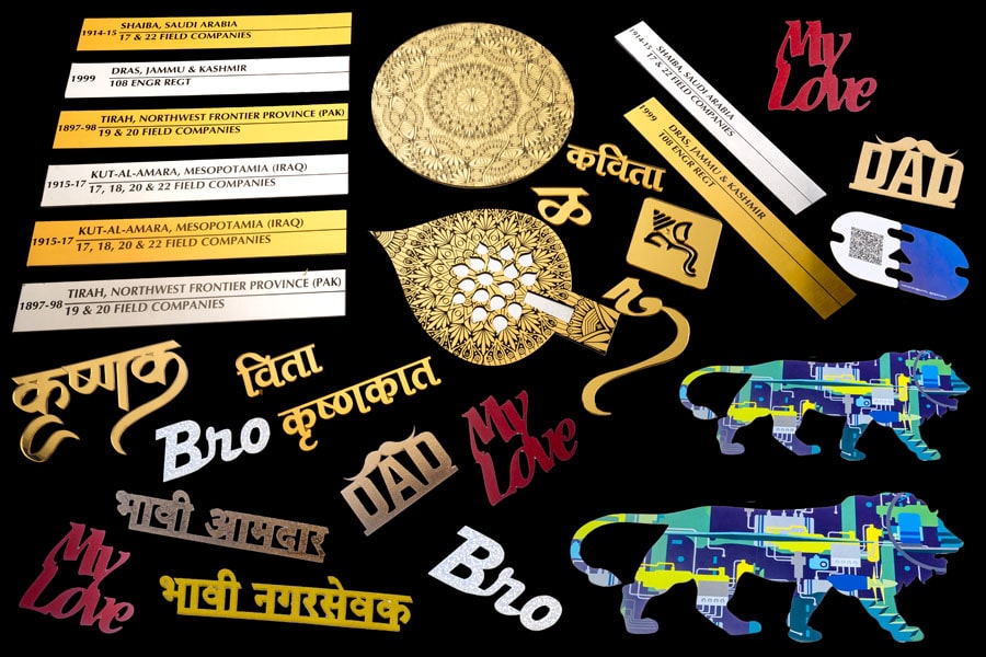 Gold and silver name plates laser engraved. Trophies cut from gold ply. Ganpati logo and marathi letters made from gold acrylic.