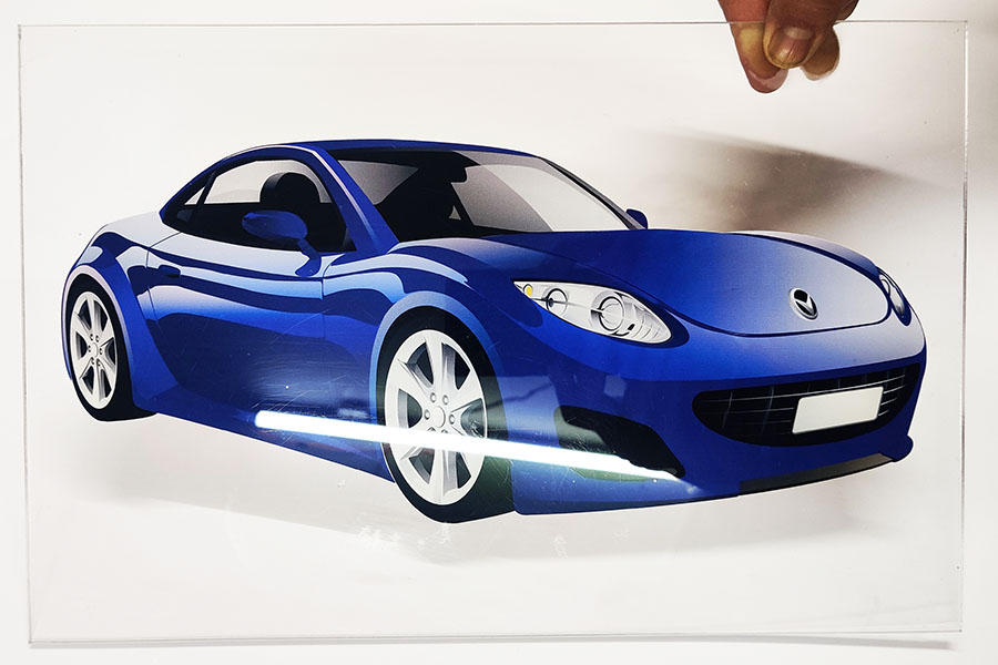Reverse pastable stickers have glue on their front face which enables us to paste them from the inside of a glass panel as shown here